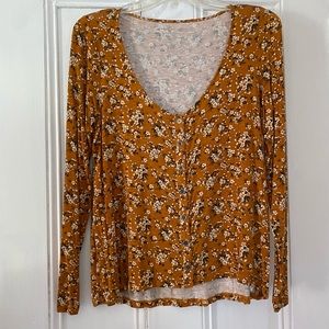 U-Neck long sleeve orange shirt.